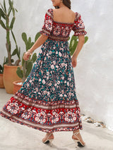 Rear view of a woman in a floral print off-the-shoulder maxi dress with puff sleeves and a tiered skirt.