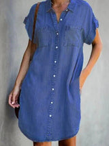 full-body view of a woman in a blue denim short-sleeve shirt dress