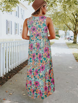 Woman wearing a floral print sleeveless maxi dress with pockets, back view