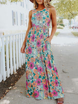 Woman wearing a floral print sleeveless maxi dress with pockets, front view
