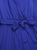 close-up of the tie waist and pleated fabric of a blue dress
