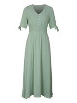 Sage green A-line maxi dress with smocked waist and tie sleeves, displayed on a white background.