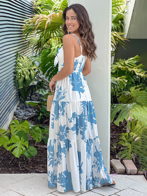 Rear view of the woman in the floral print maxi dress, showcasing the back and tiered skirt.