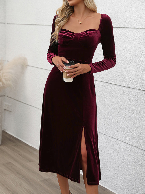 Woman in a wine-colored velvet midi dress with a sweetheart neckline and long sleeves, holding a coffee cup.