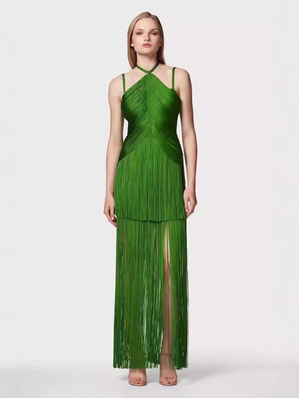 woman wearing a long green halter neck dress with tiered fringe and a high leg slit