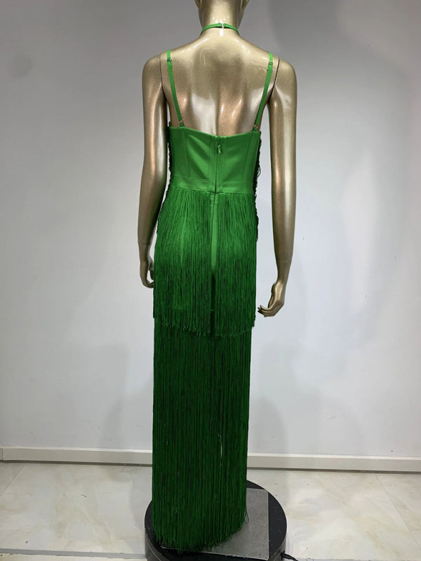 back view of a mannequin wearing a long green halter neck dress with tiered fringe and a high leg slit