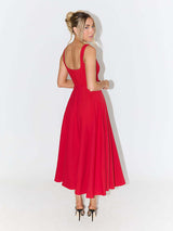 back view of woman in red fit and flare midi dress with square neckline