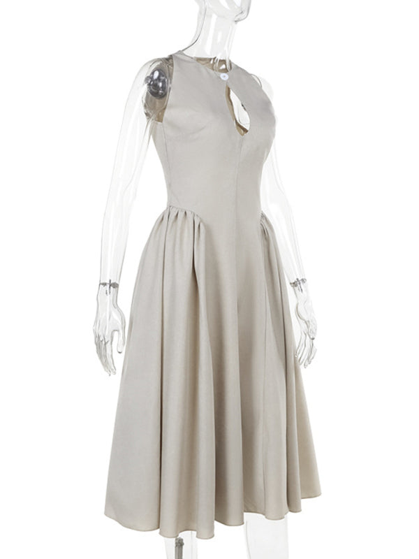 Mannequin displaying the side view of a beige sleeveless A-line dress with a keyhole neckline and a pleated skirt.