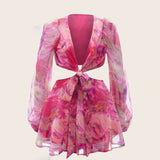 Pink floral print two-piece set with a deep V-neck, front tie, and cut-out detail, displayed flat.