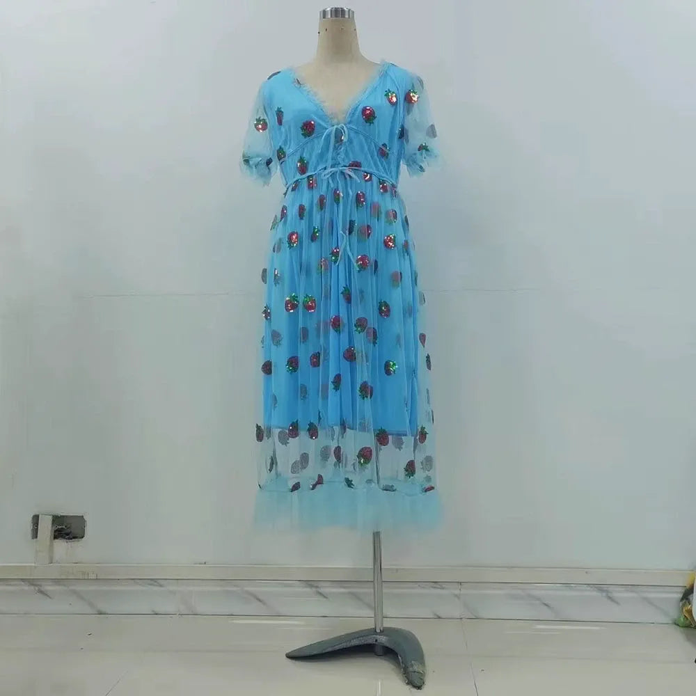 A light blue midi dress with a strawberry print and puff sleeves displayed on a mannequin.