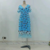 A light blue midi dress with a strawberry print and puff sleeves displayed on a mannequin.