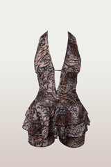 Front view of a leopard print halter romper with a deep V-neck and tiered ruffles.