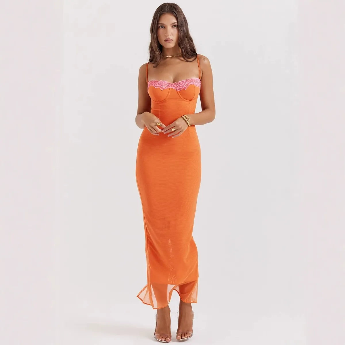 woman wearing a long orange ribbed knit dress with lace trim and sheer hem