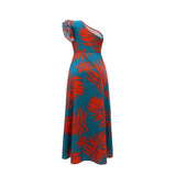A teal and red tropical print maxi dress with a high slit and one-shoulder design displayed from the side on a white background.