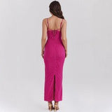 back view of a woman wearing a long fuchsia ribbed knit dress with lace trim and lace-up detail