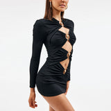 Side view of a model in a black fitted mini dress with cut-out details