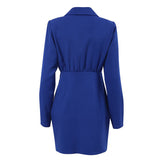 Back view of a royal blue blazer dress with a wrap front and tie detail.