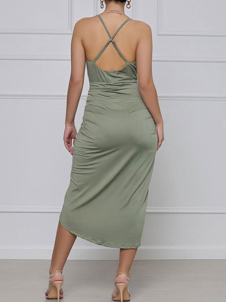 back view of a green ruched halter dress with an asymmetrical hemline