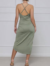 back view of a green ruched halter dress with an asymmetrical hemline