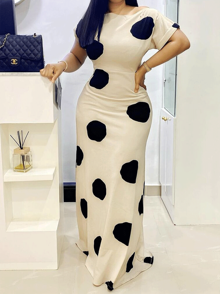 full body shot of a woman in a polka dot maxi dress