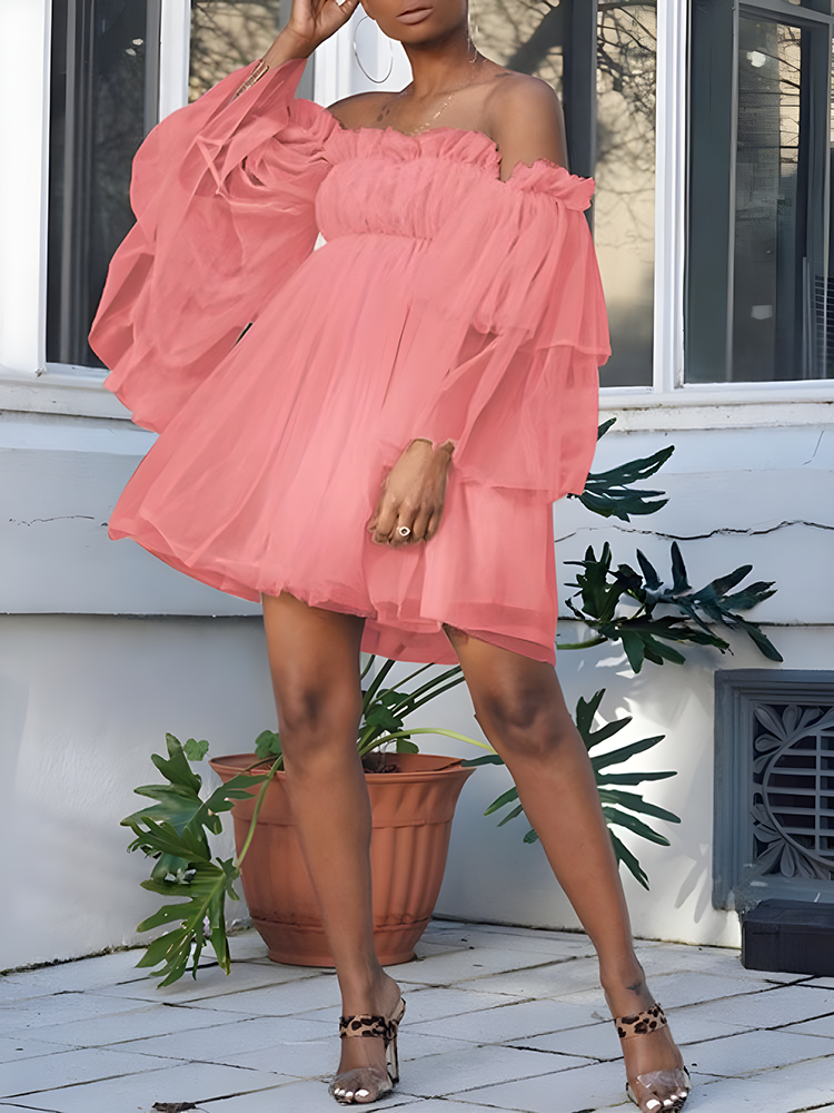 woman wearing an off-the-shoulder coral tulle dress with tiered bell sleeves