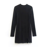 black long-sleeved dress with high neckline, side slit, and beaded trim displayed flat