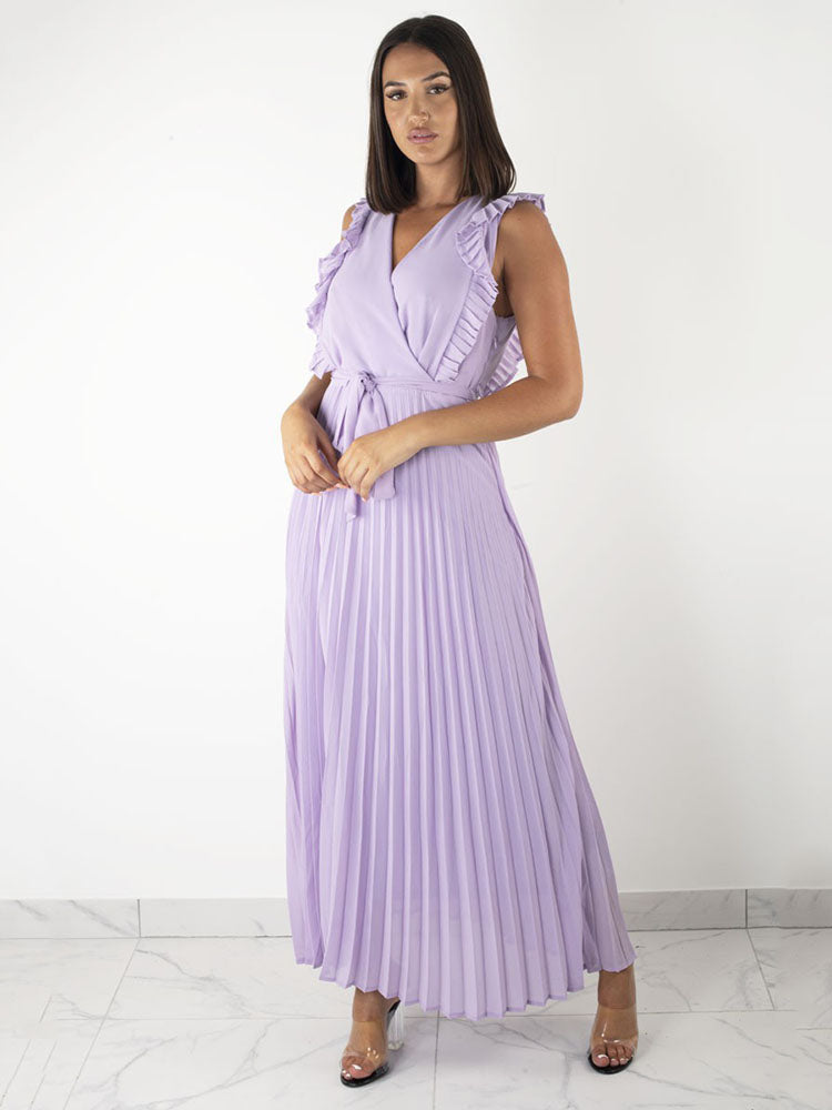 woman wearing a long purple pleated dress with ruffled sleeves and a tie belt