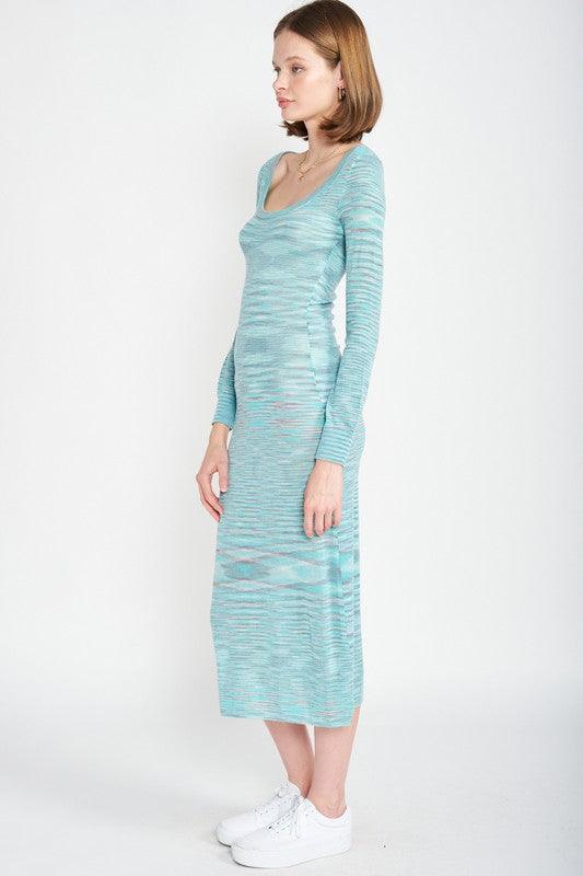 Side view of a woman wearing a long-sleeved, scoop-neck, midi-length, bodycon dress with a striped pattern in shades of blue and grey, paired with white sneakers.
