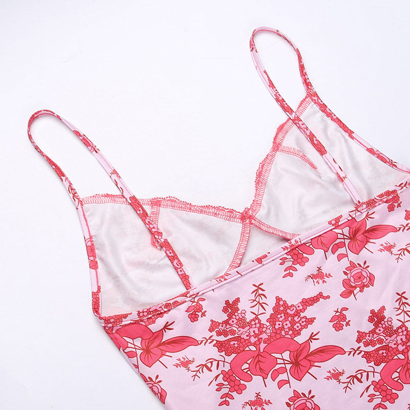 Detail of the spaghetti straps and lace trim on a pink floral print slip dress