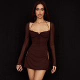 Woman wearing a brown sheer mesh mini dress with long bell sleeves and cut-out sides.