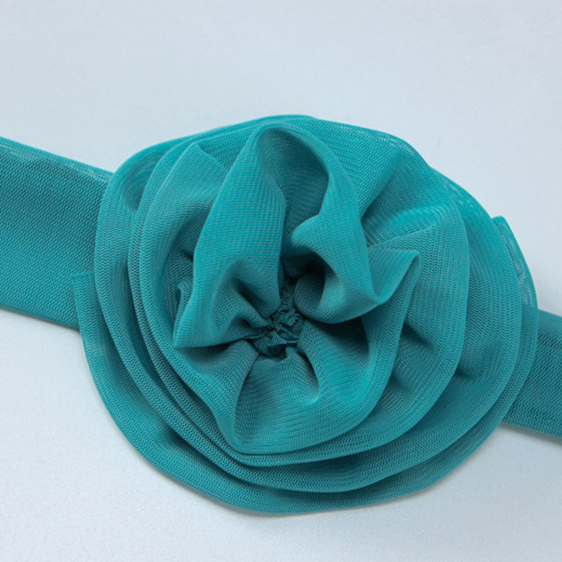 Close-up of the teal mesh floral applique on the dress.