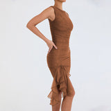 Woman wearing a brown sheer mesh ruched dress with a ruffled asymmetrical hemline, posing from the side.