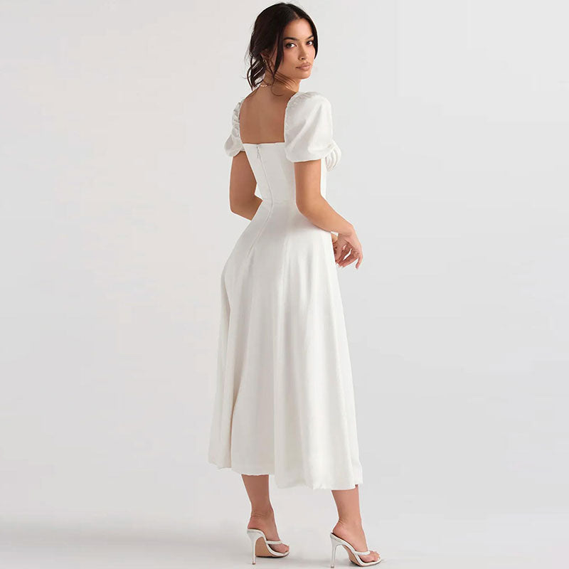 Back view of a woman in a white midi dress with puff sleeves.