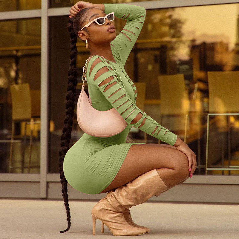 woman in a green bodycon dress with cutout sleeves and a long braid