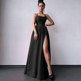 Full-length view of a woman wearing a black satin formal gown