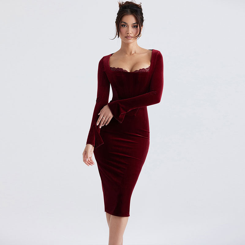 Woman wearing a long-sleeved, burgundy velvet sheath dress with a square neckline and lace trim.