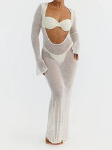 woman wearing a white sheer knit maxi dress with a cut-out detail and long sleeves