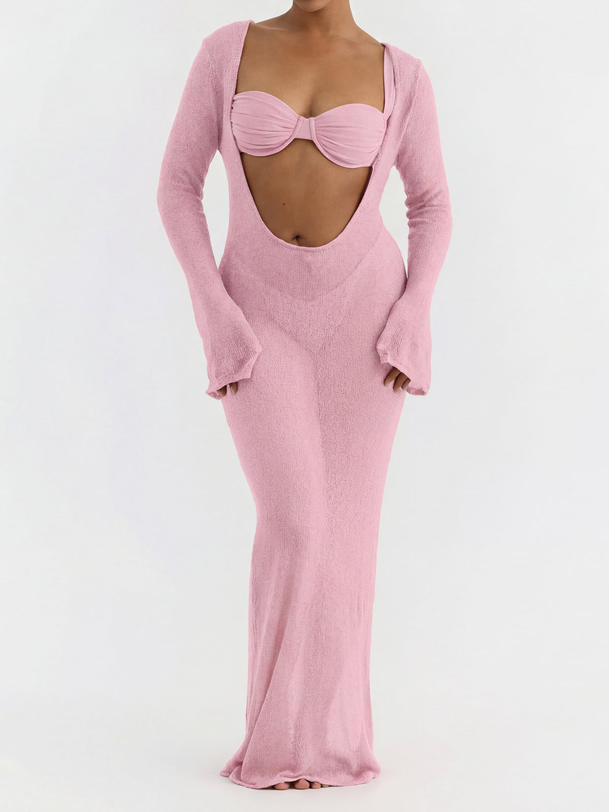 woman wearing a pink sheer knit maxi dress with a cut-out detail and long sleeves