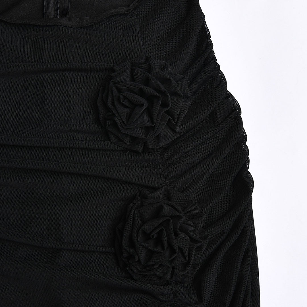Close-up of the black mesh skirt showing ruched detailing and floral embellishments.