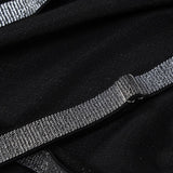 Close-up of the sparkling glitter strap detail on a black gown
