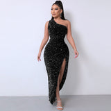 Full-length view of a woman in a black sequined one-shoulder gown with a thigh-high slit.