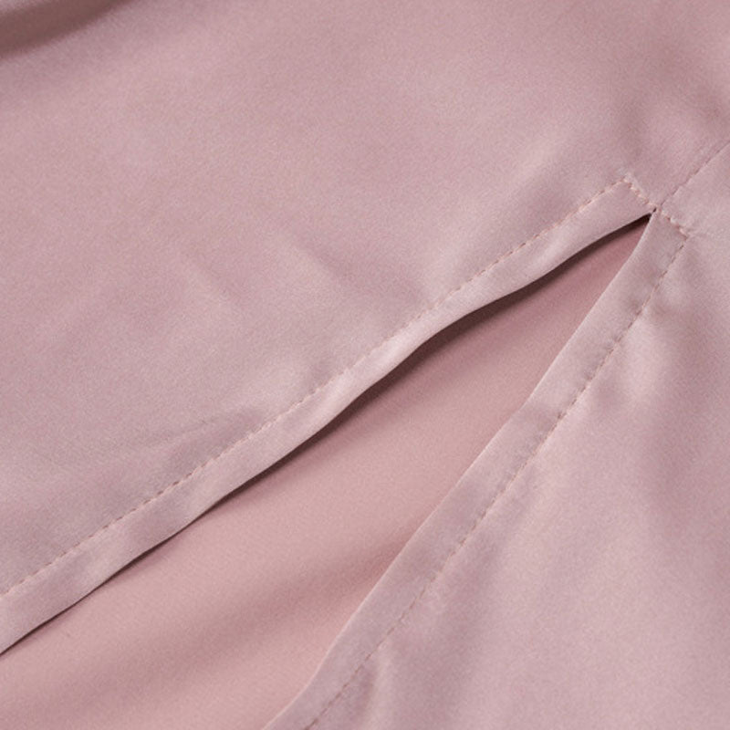 Detail of the high slit on a pink satin dress