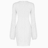 back view of a white sequined mini dress with long bishop sleeves