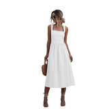Woman wearing a white sleeveless square neck midi dress with a fitted bodice and A-line skirt.