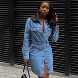 Full-body view of a woman in a denim shirt dress.
