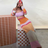 woman posing in a striped ribbed knit midi dress