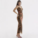 Side view of a woman in a ruched, floral and animal print mesh dress with a sweetheart neckline and spaghetti straps.
