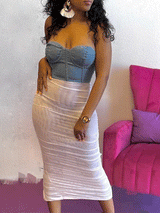 woman wearing a denim bustier top and a ruched white mesh midi skirt