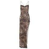 A leopard print maxi dress with a high slit and chain straps, shown flat.