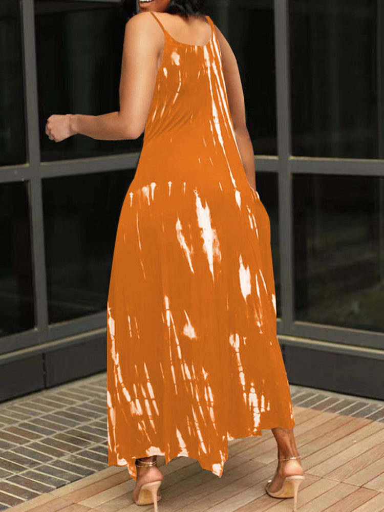 Back view of a woman in an orange and white tie-dye maxi dress, showcasing the flowy silhouette.